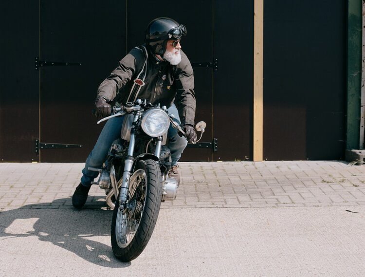 old rider on vintage bike - motorcycle travel