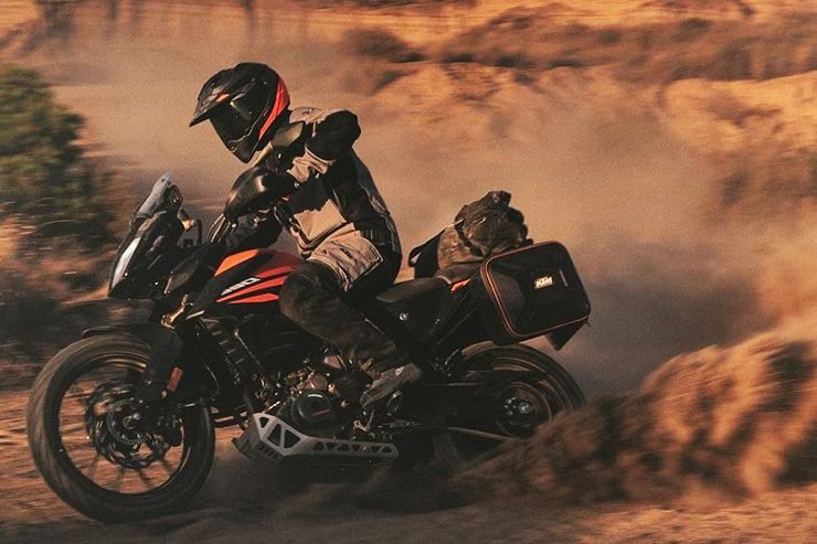 ktm kicking up dust in the desert - adventure motorcycling