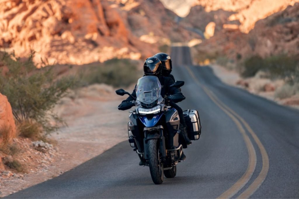 rider and passenger on triumph motorbike