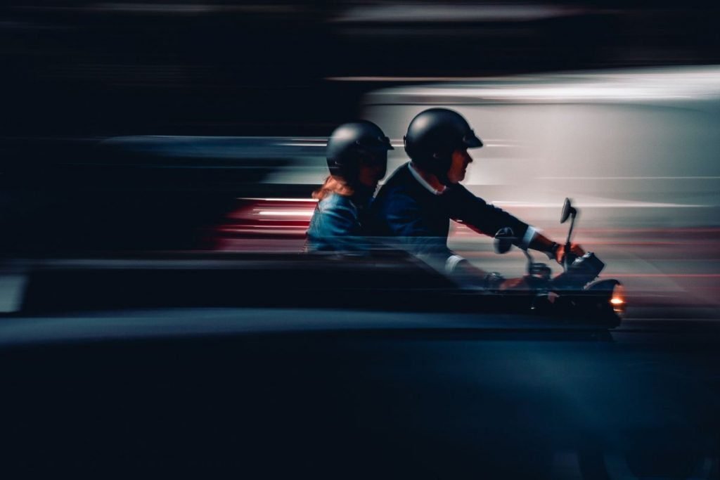 motorcyclist and passenger with open helmets