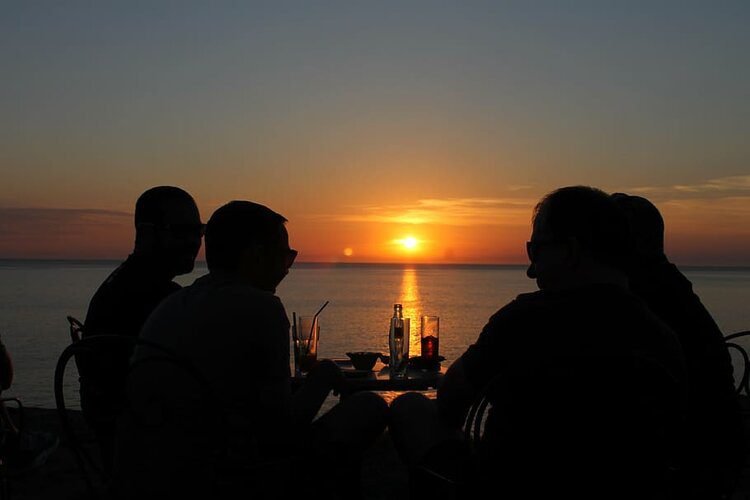 group of friends drinking at sunset