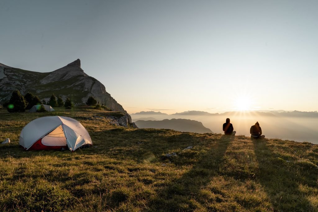 tent in the mountains at sunrise - motorcycle camping