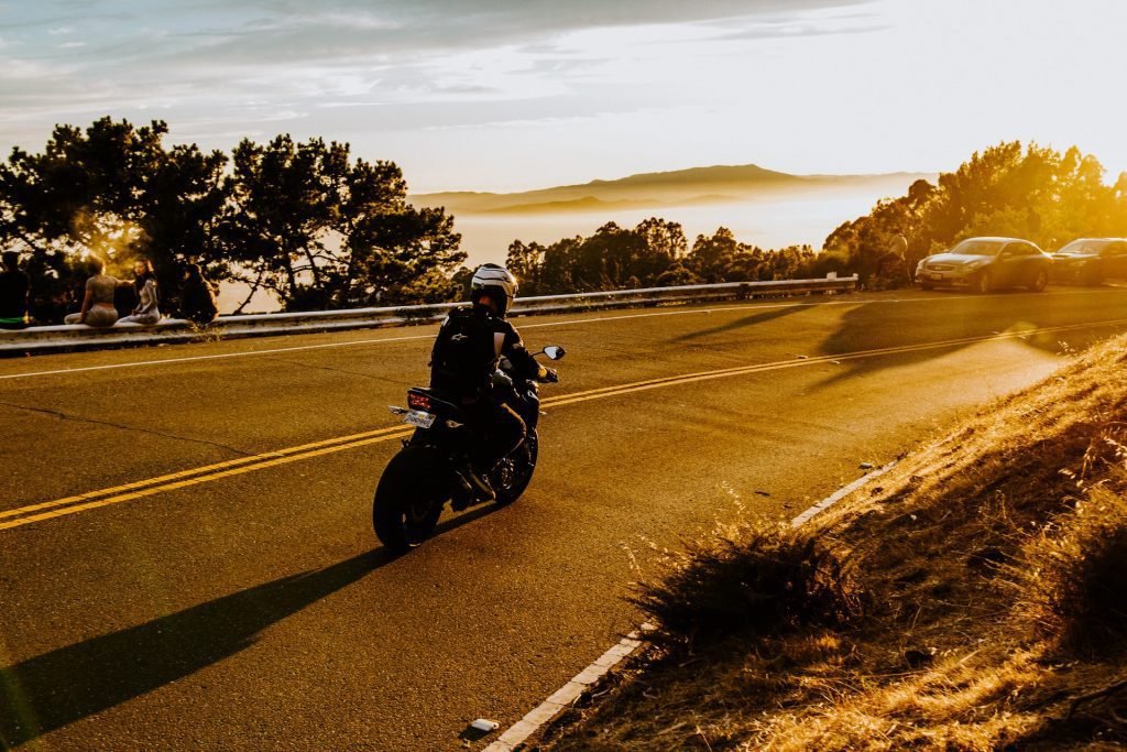 biker on mountain road sunrise