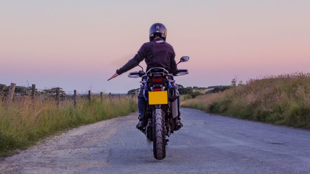 biker code hand signals - slow down