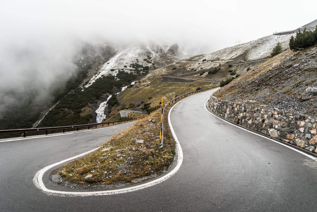 stelvio pass in rain - hairpin bends on a motorcycle