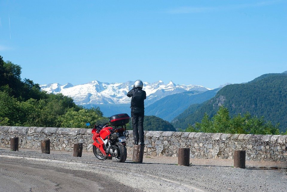 biker taking photograph in mountains