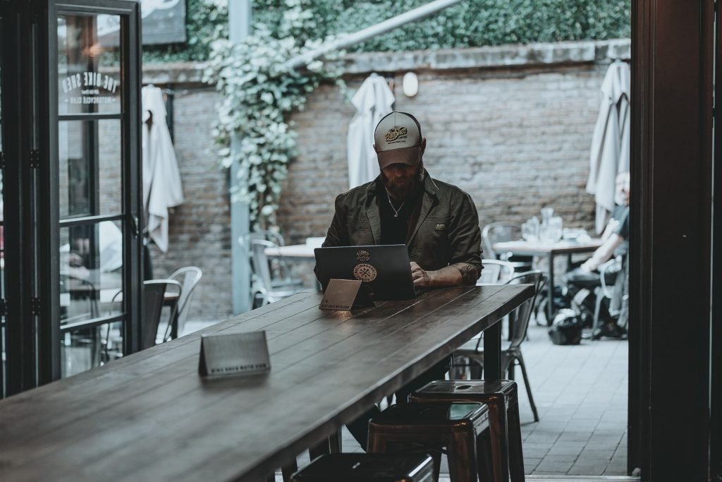 biker in bar on laptop