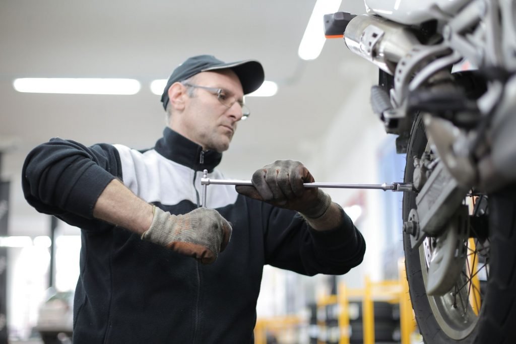 mechanic working on bike -motorcycle tour breakdown