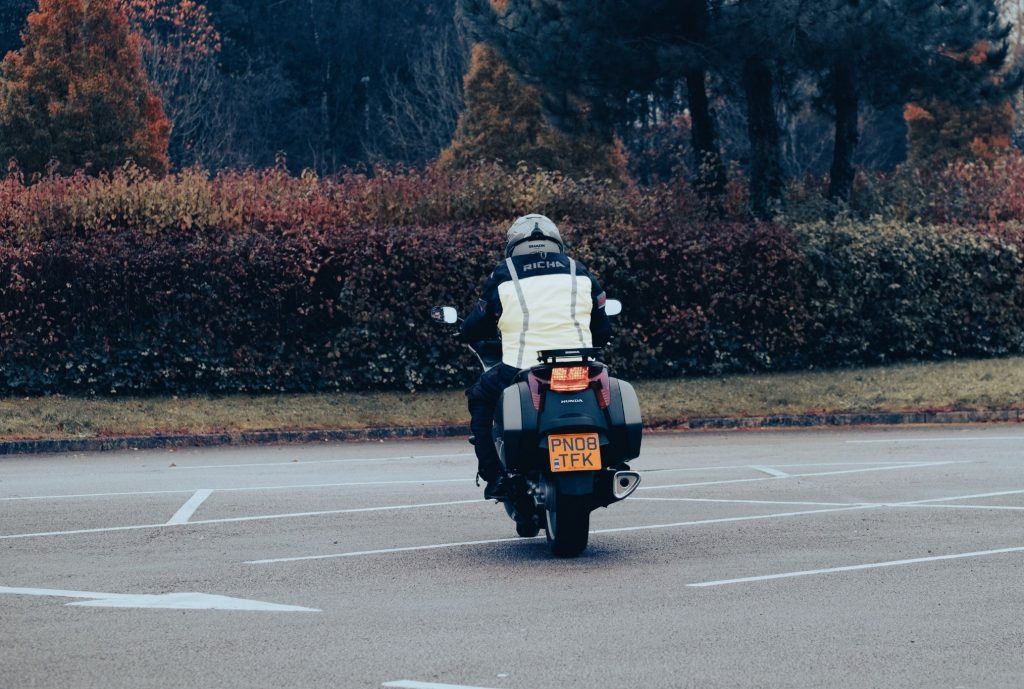 slow-speed riding for motorcycle touring - biker dragging brake in carpark