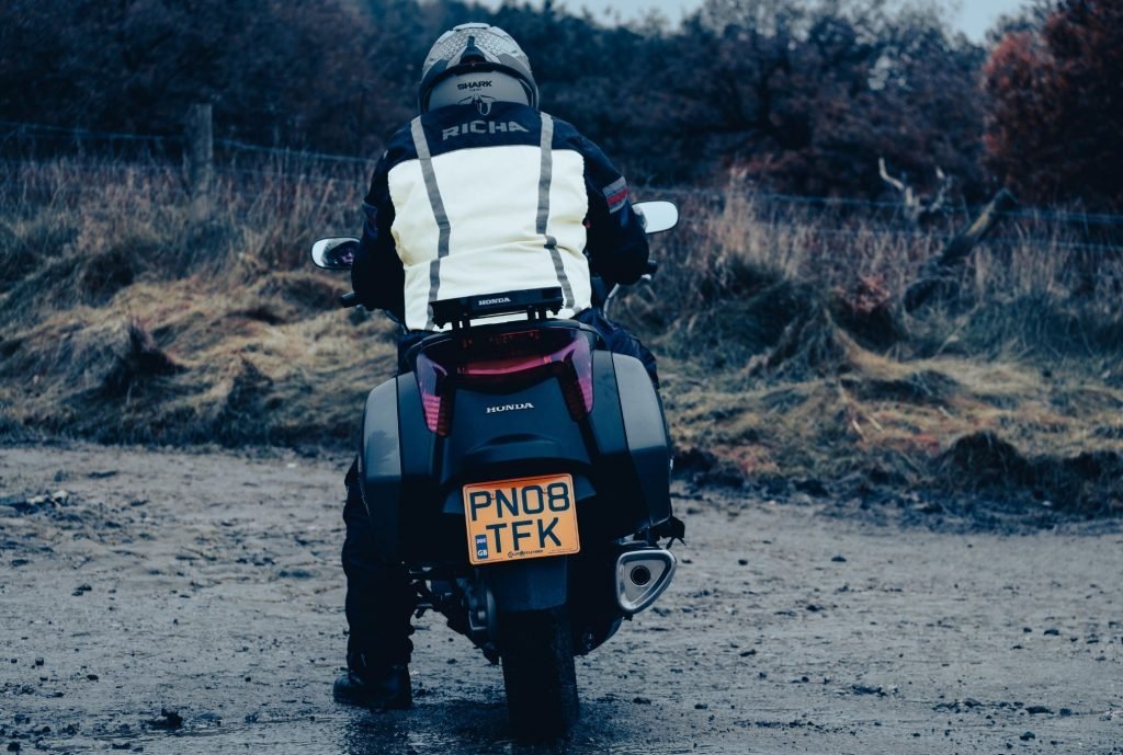 slow-speed riding for motorcycle touring - biker left foot down