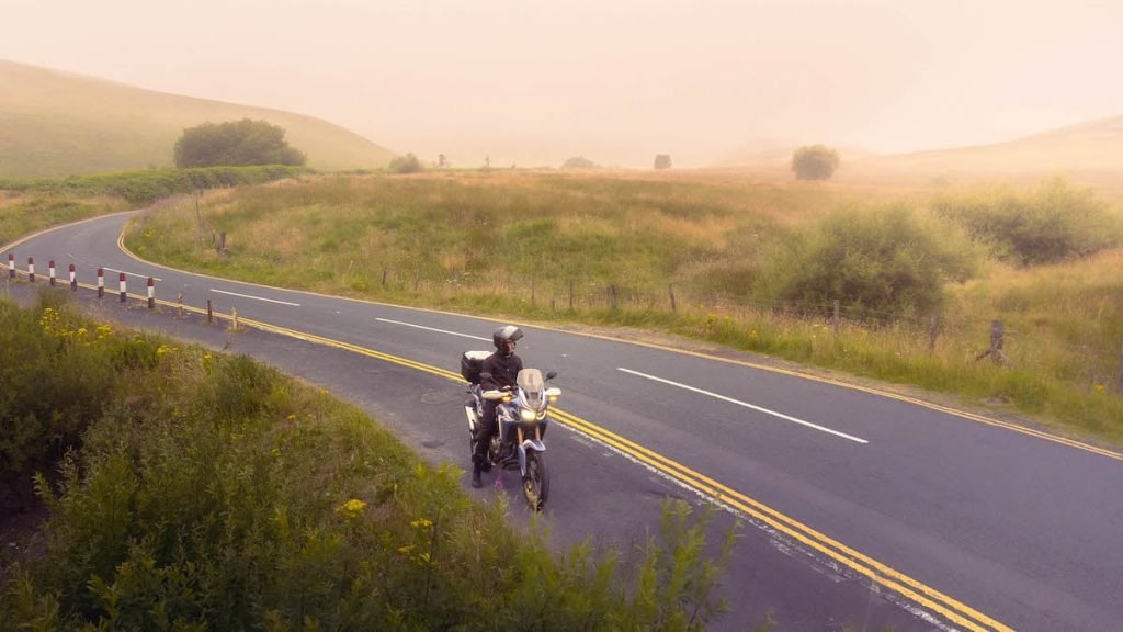 Honda Africa Twin in countryside at sunrise - motorcycle touring trends