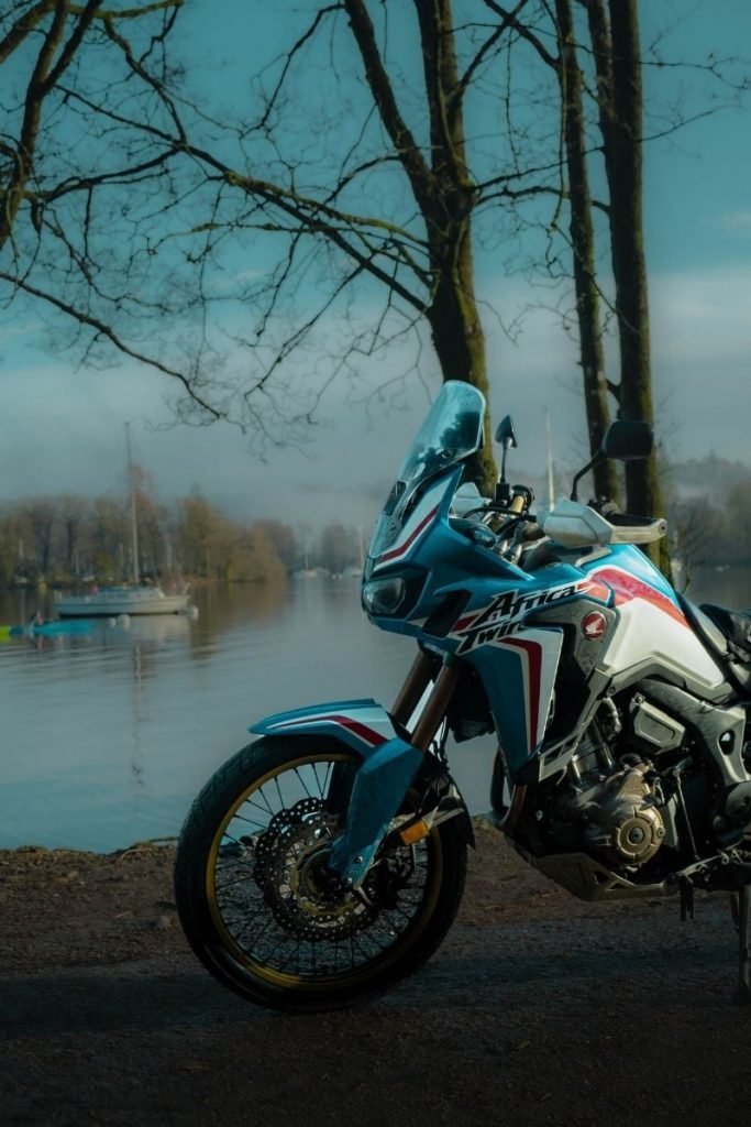 honda africa twin at lakeside in fog - boats in background - better smartphone photos
