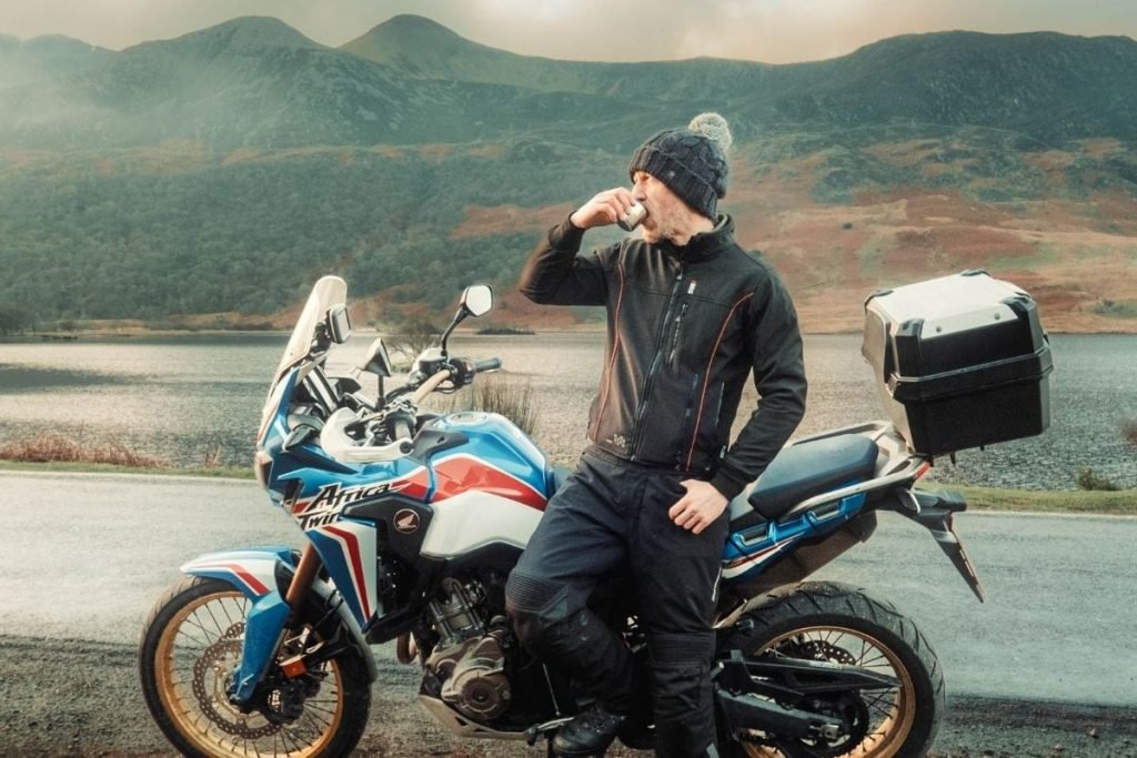 rider wearing keis heated jacket drinking hot coffee