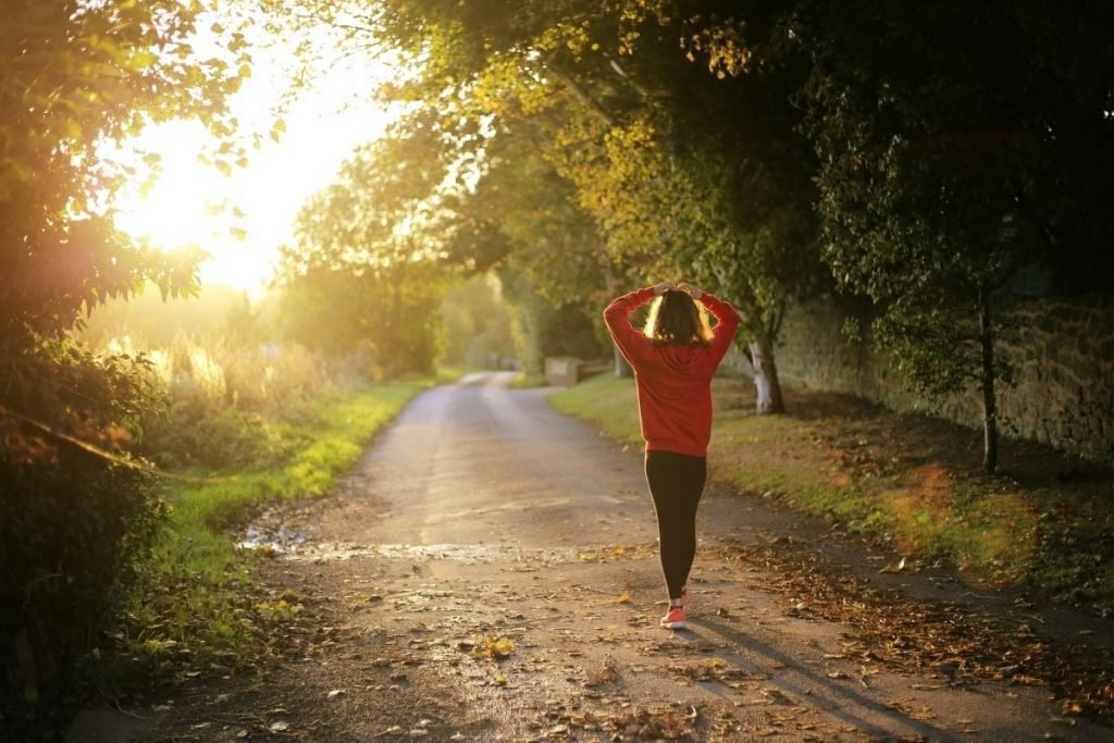 stay fit on your motorcycle tour - woman running in country park