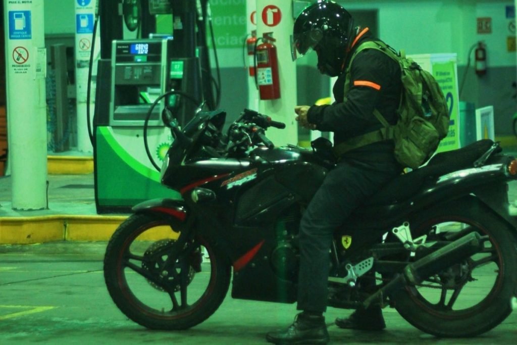 fuel prices on your motorcycle - biker at BP gas station