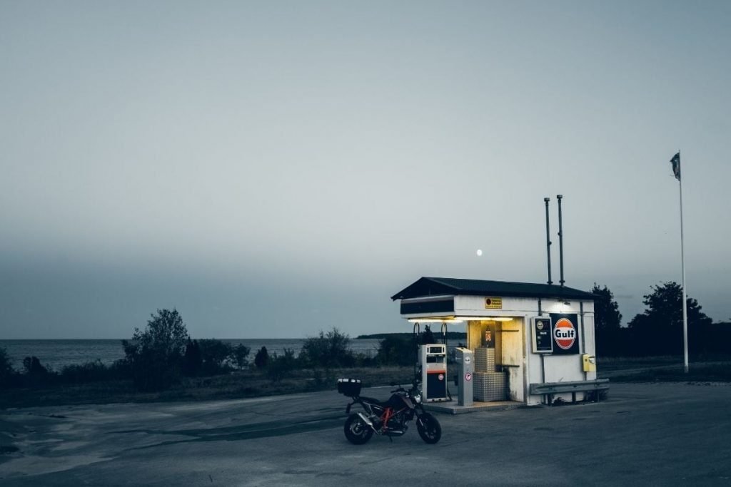 fuel prices on your motorcycle tour - lone bike at deserted gas station