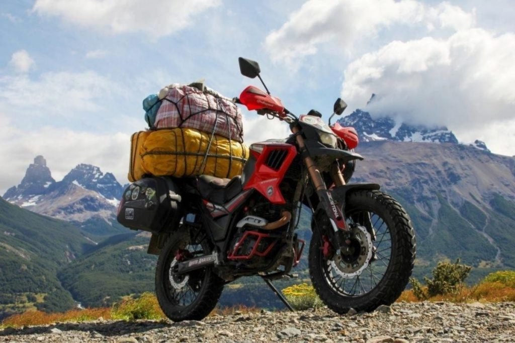 fully ladened dirt bike on gravel path - reasons not to buy panniers