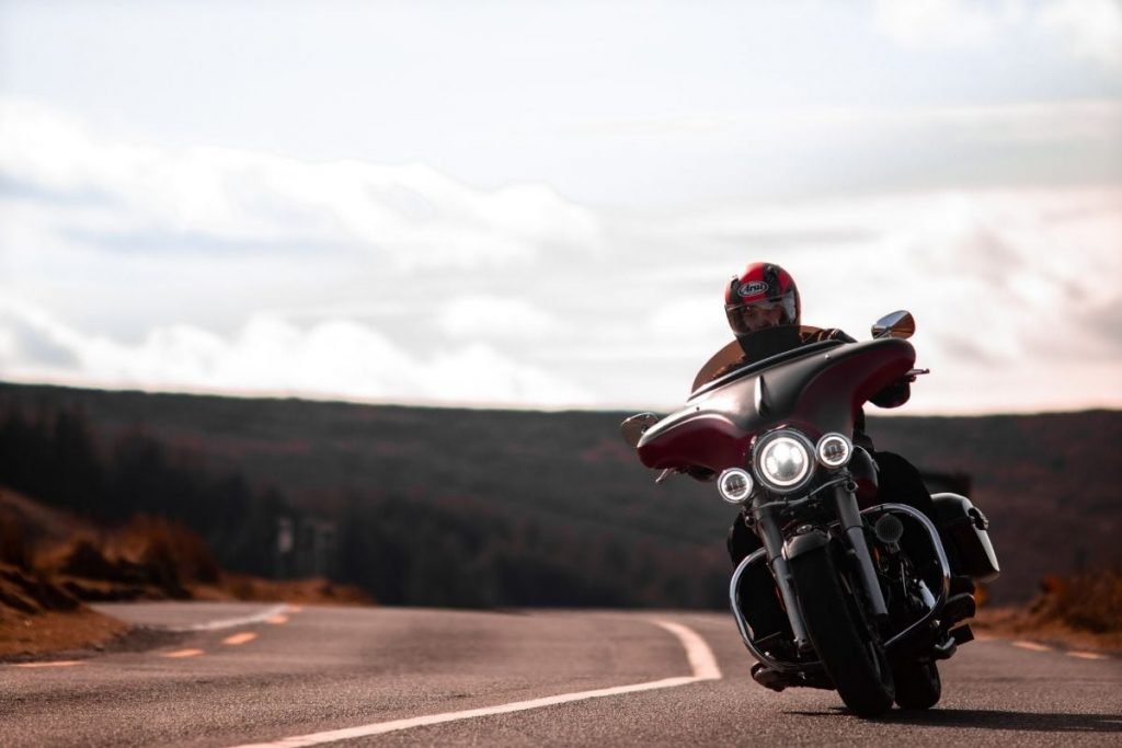 cruiser on empty road - cut costs on your motorcycle trip