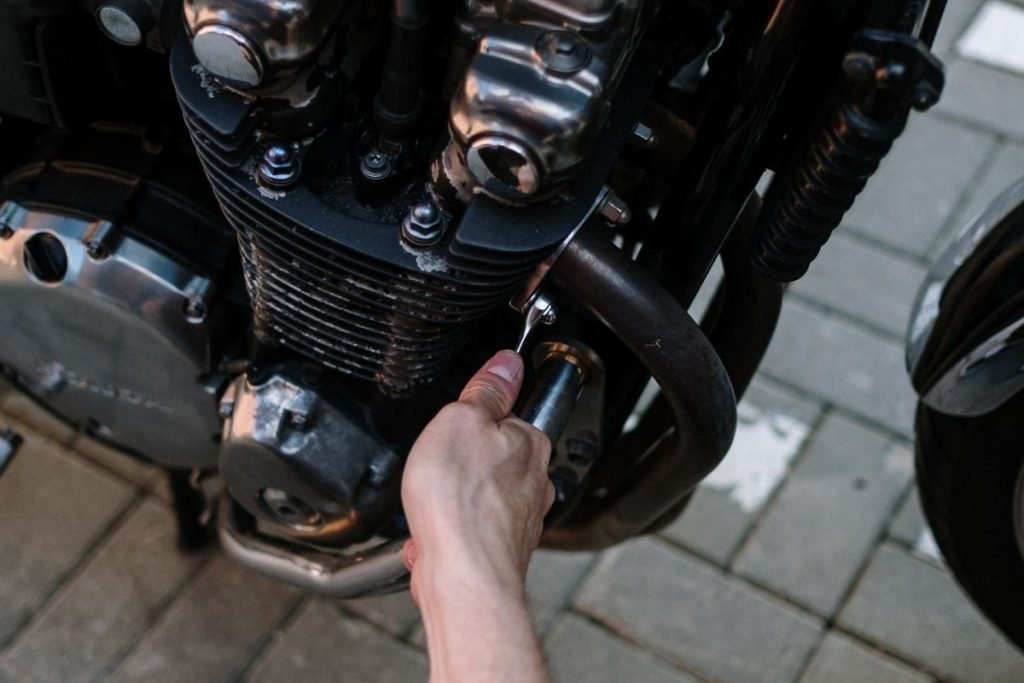 mechanic fixing bike with spanner