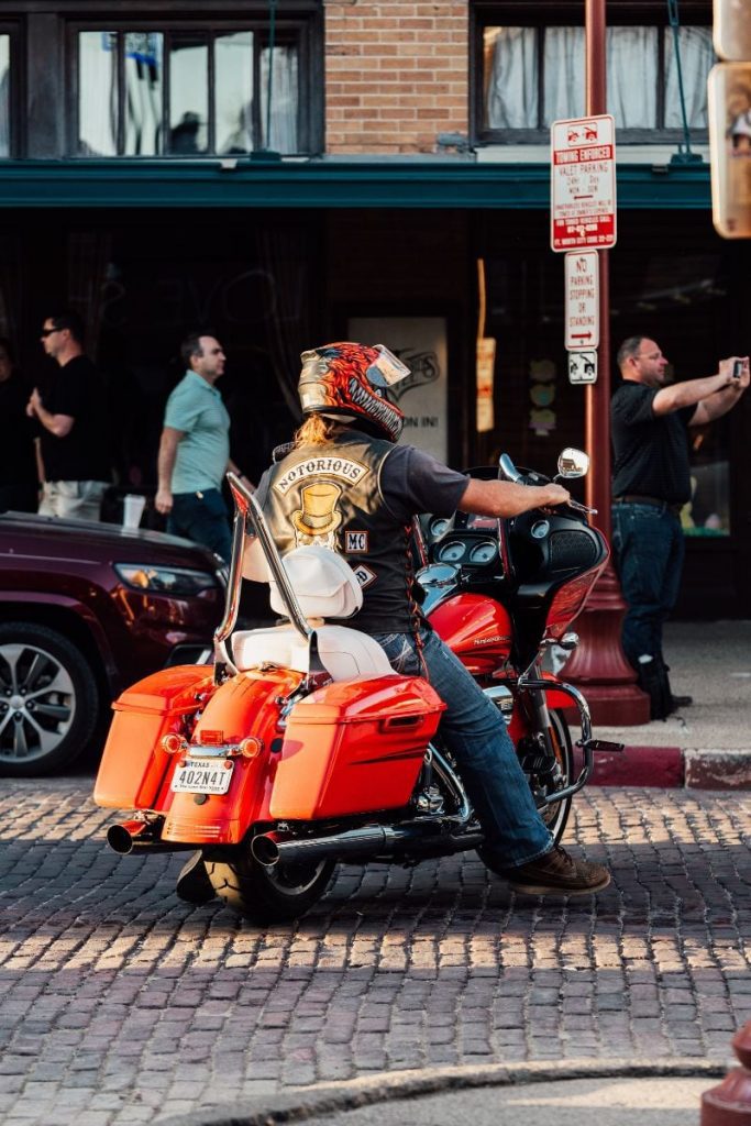 old school Harley-Davidson rider on orange bike