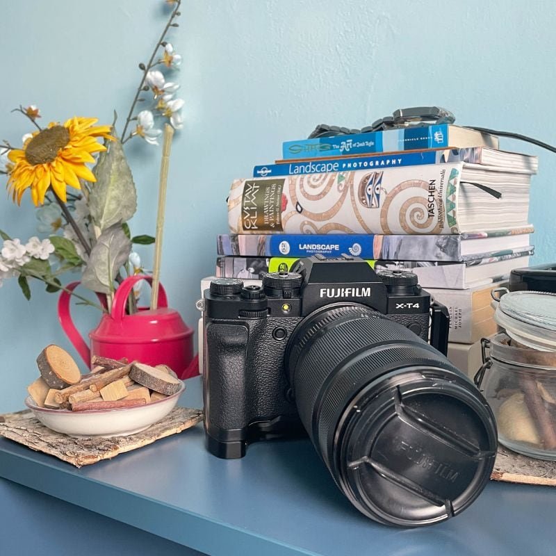fuji x-t4 on blue shelf with books and wood chippings