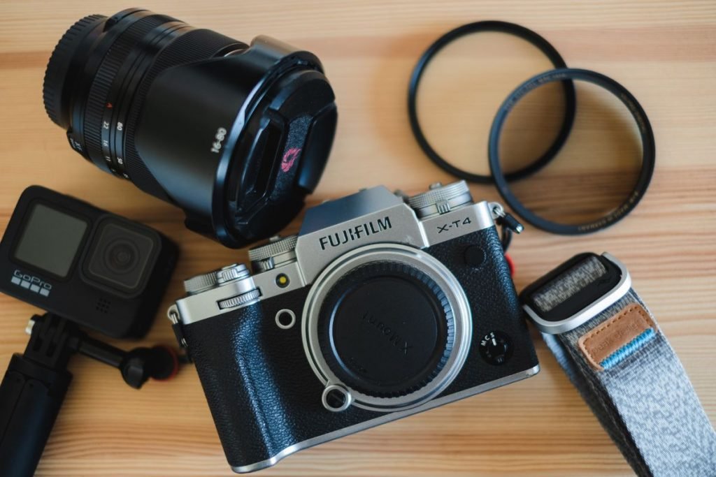 fuji x-t4 and accessories on wooden table - best camera setup motorcycle travel
