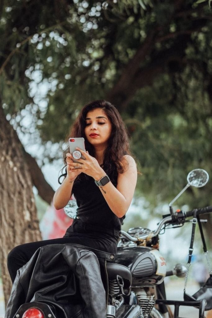 best motorcycle smartphone holders - woman using phone on motorbike