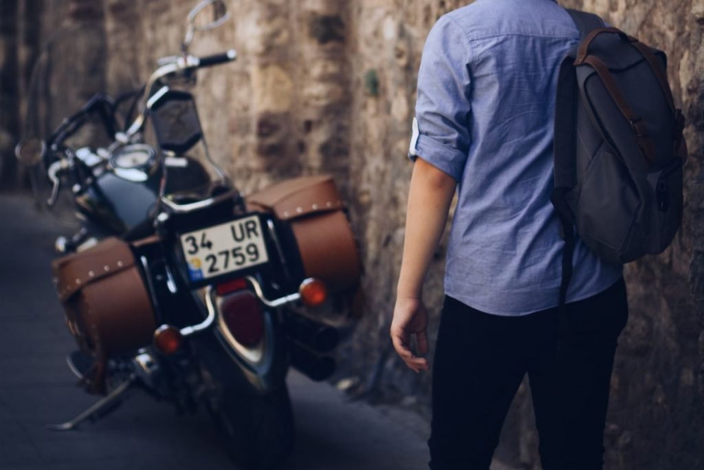 cruiser motorbike man with rucksack