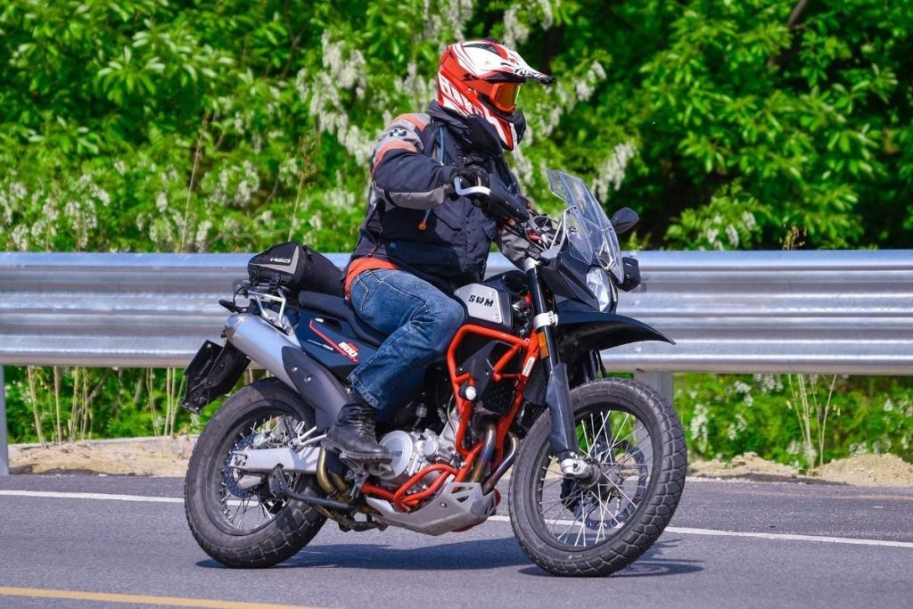 rider and motorbike with tail pack - organised motorcycle touring