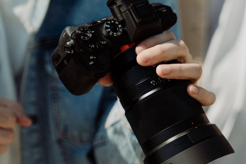 photographer holding camera - motorcycle photography tips