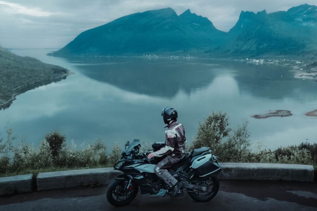 motorcycle touring norway - rider in senja with mountains